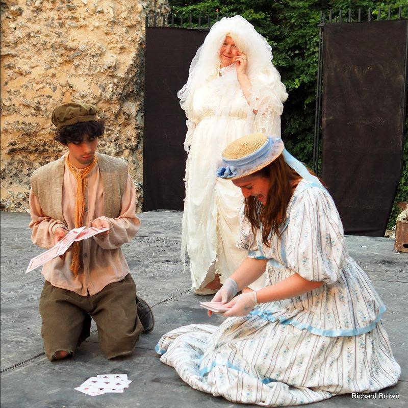Pip and Estella play cards, watched by Miss Havisham